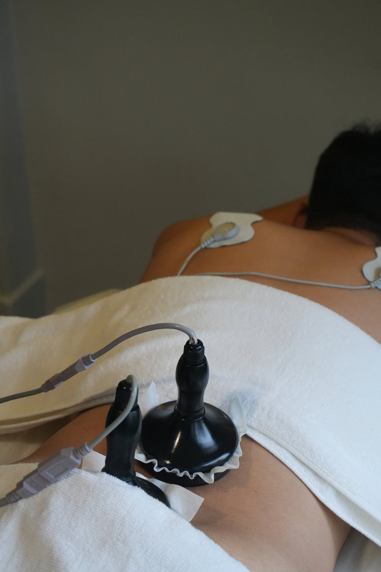 Mannequin torso with medical equipment on a plain background